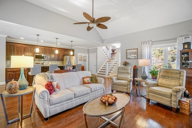 living area with stairs, recessed lighting, a ceiling fan, lofted ceiling, and hardwood / wood-style flooring