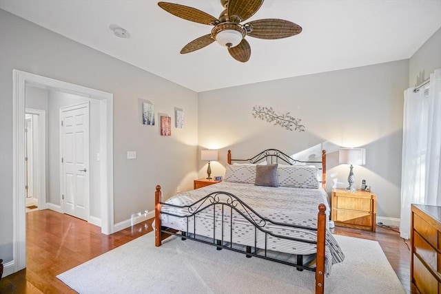 bedroom with baseboards, ceiling fan, and wood finished floors