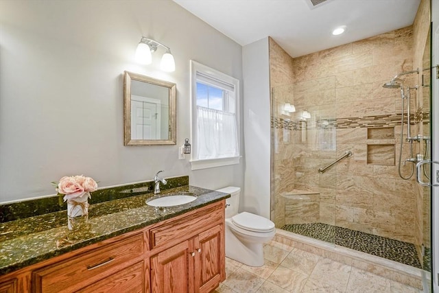 full bath featuring vanity, recessed lighting, toilet, and a shower stall