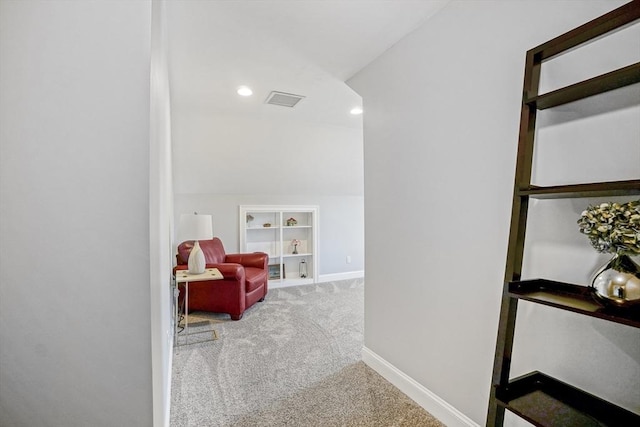living area with carpet floors, visible vents, built in features, baseboards, and recessed lighting