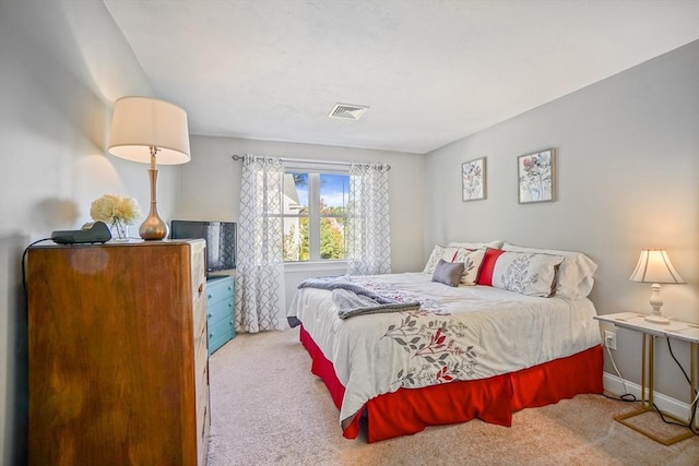 carpeted bedroom featuring baseboards and visible vents