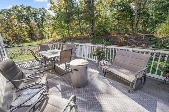 view of patio with a wooden deck and outdoor dining space