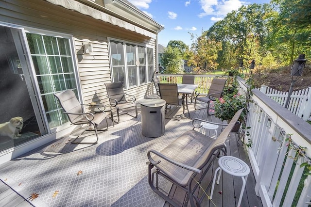view of patio featuring outdoor dining area and a wooden deck