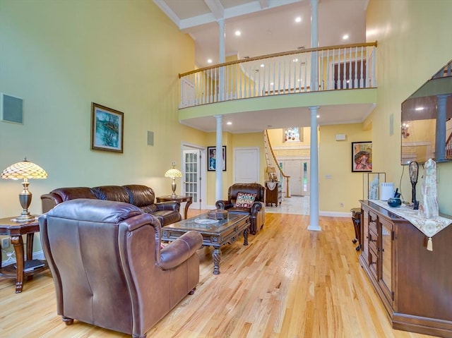 14 Nassau Dr, Winchester, MA 01890 - living area with decorative columns, recessed lighting, light wood-style flooring, and a high ceiling