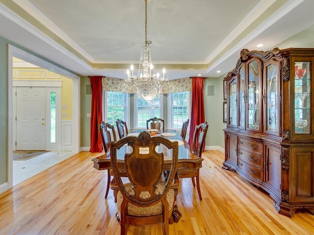 14 Nassau Dr, Winchester, MA 01890 - dining space with ornamental molding, a tray ceiling, light wood finished floors, and a notable chandelier