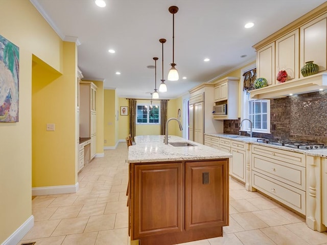 14 Nassau Dr, Winchester, MA 01890 - kitchen featuring crown molding, light stone countertops, appliances with stainless steel finishes, a sink, and cream cabinets