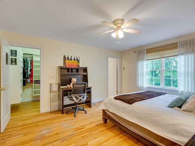 14 Nassau Dr, Winchester, MA 01890 - bedroom with light wood-type flooring, baseboards, and a walk in closet