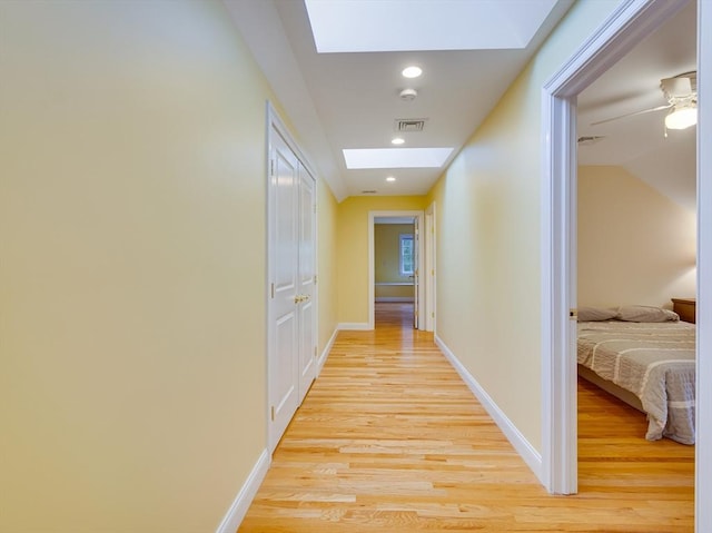 14 Nassau Dr, Winchester, MA 01890 - hallway featuring a skylight, light wood-style floors, and baseboards