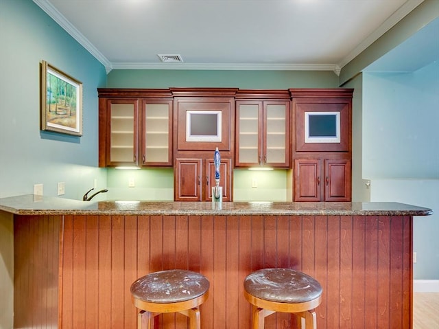 14 Nassau Dr, Winchester, MA 01890 - bar featuring ornamental molding, visible vents, and indoor wet bar