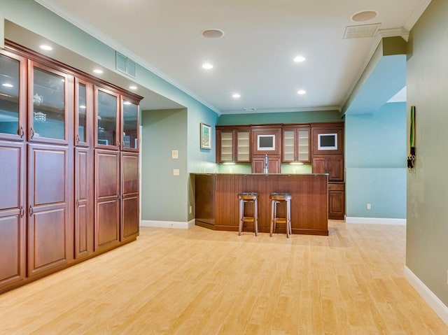 14 Nassau Dr, Winchester, MA 01890 - bar featuring crown molding, light wood finished floors, baseboards, and visible vents