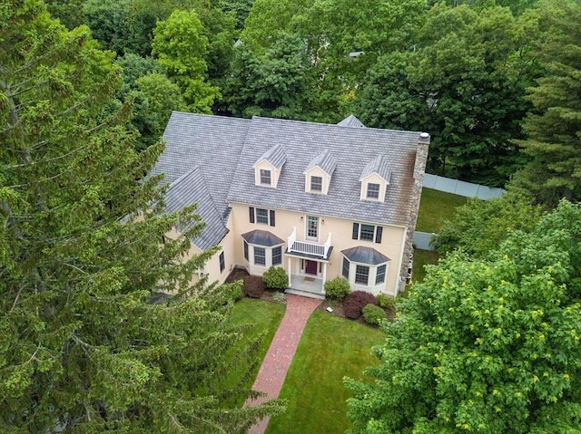 14 Nassau Dr, Winchester, MA 01890 - view of front of property with a view of trees, a standing seam roof, fence, and a front lawn