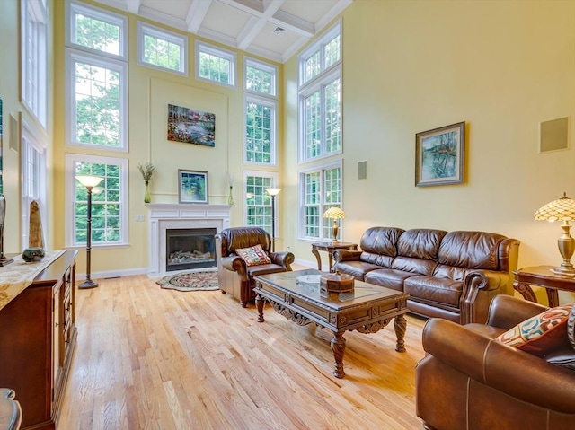 14 Nassau Dr, Winchester, MA 01890 - living area with a high ceiling, a fireplace with flush hearth, light wood-style floors, beam ceiling, and coffered ceiling