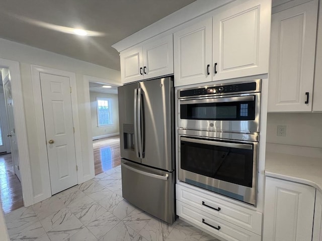 kitchen with stainless steel appliances and white cabinetry