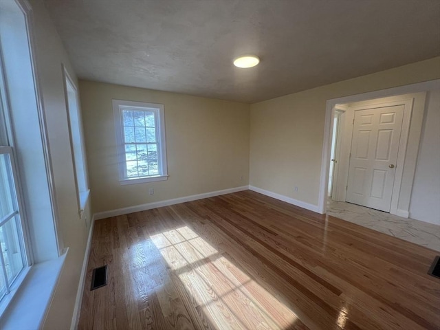 spare room with light wood-type flooring