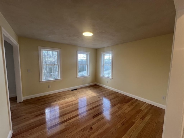 empty room with light hardwood / wood-style flooring