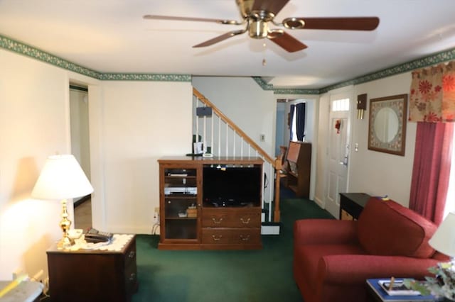 carpeted living room featuring stairs and ceiling fan