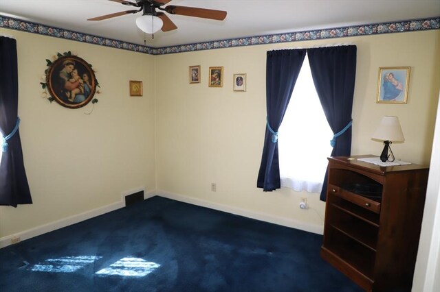 carpeted spare room with visible vents, ceiling fan, and baseboards