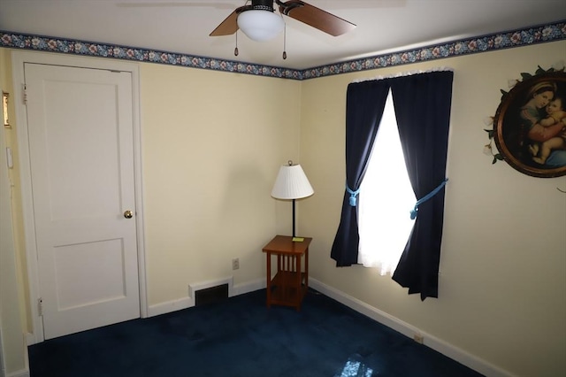 interior space featuring ceiling fan and baseboards