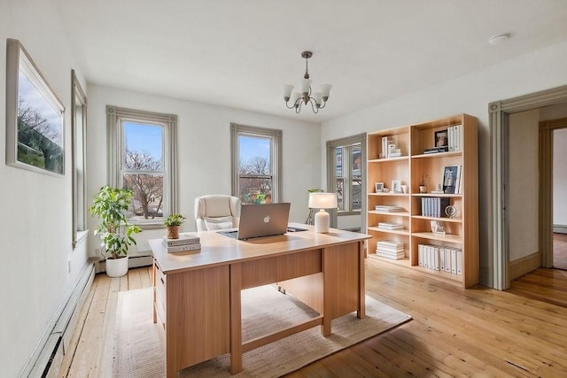 office featuring light wood-type flooring, baseboard heating, and a chandelier