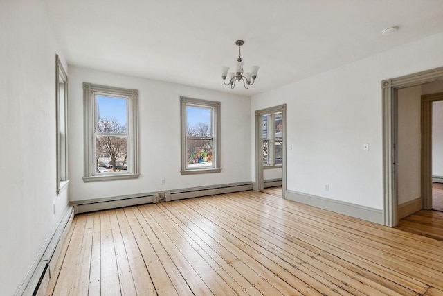 spare room featuring a baseboard radiator, baseboards, a notable chandelier, and light wood-style flooring