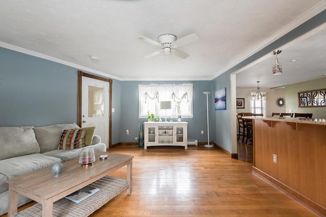 living area with light wood-style flooring, ceiling fan with notable chandelier, baseboards, and ornamental molding