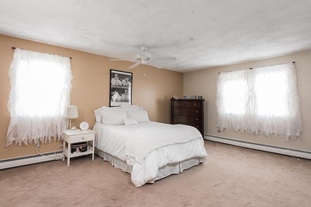 bedroom featuring carpet flooring, a baseboard heating unit, and a ceiling fan