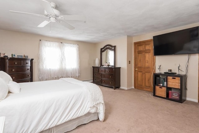 bedroom with a ceiling fan, carpet, and baseboards