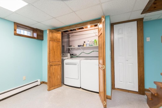 washroom featuring a baseboard heating unit, separate washer and dryer, light floors, and laundry area