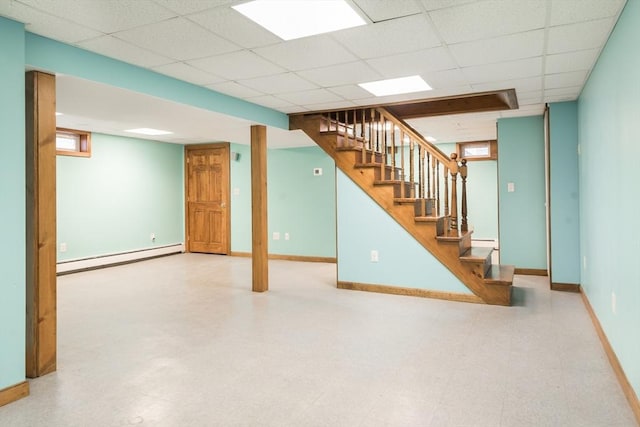 basement with stairs, tile patterned floors, baseboards, and baseboard heating