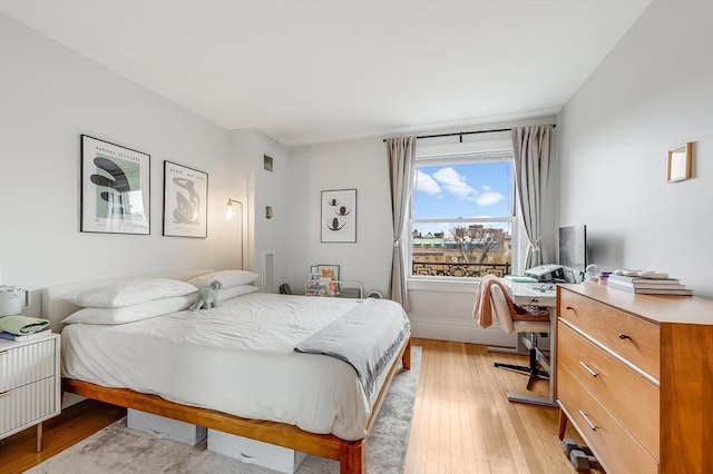 bedroom with visible vents and light wood-type flooring