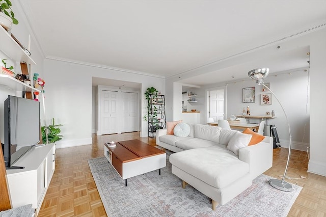 living room with baseboards and crown molding