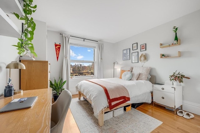 bedroom featuring wood finished floors and baseboards