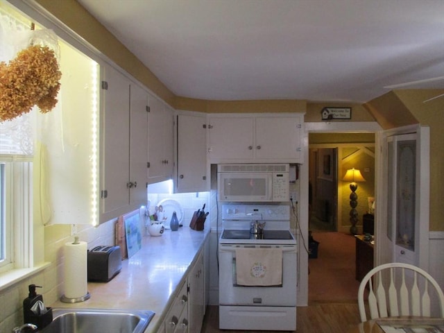 360 Russells Mills Rd, Dartmouth, MA 02748 - kitchen featuring white appliances, a sink, light countertops, white cabinetry, and backsplash