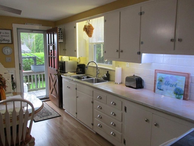 360 Russells Mills Rd, Dartmouth, MA 02748 - kitchen featuring a sink, white cabinetry, healthy amount of natural light, and stainless steel microwave