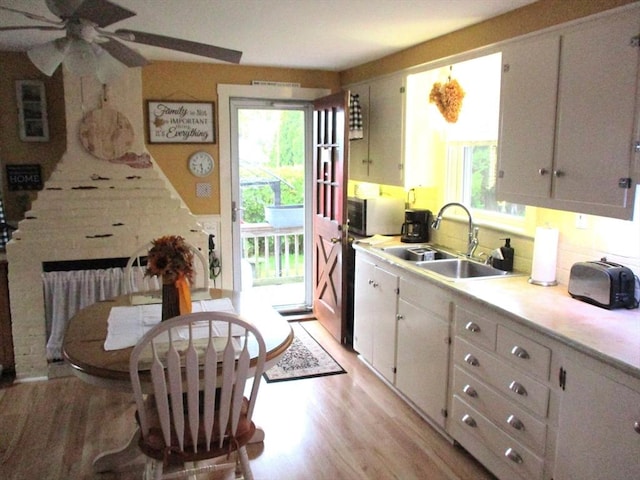 360 Russells Mills Rd, Dartmouth, MA 02748 - kitchen featuring a sink, light wood-style flooring, stainless steel microwave, a ceiling fan, and light countertops