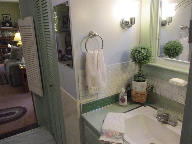360 Russells Mills Rd, Dartmouth, MA 02748 - bathroom with a sink, tile walls, wainscoting, and tile patterned flooring
