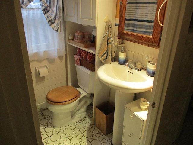 360 Russells Mills Rd, Dartmouth, MA 02748 - bathroom featuring tile walls, toilet, a sink, and tasteful backsplash
