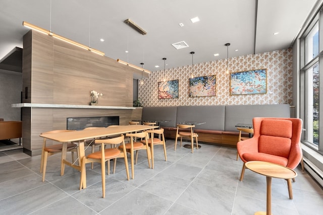 tiled dining space with a baseboard heating unit