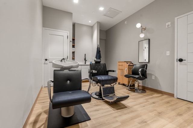 living area featuring light wood-type flooring and sink