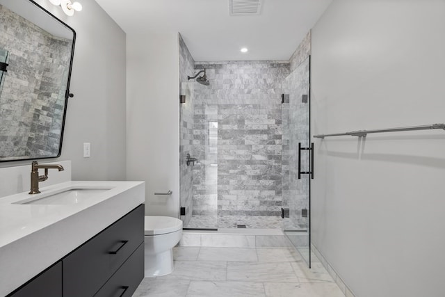 bathroom featuring vanity, toilet, and an enclosed shower