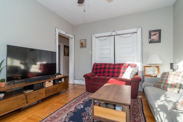 living room featuring hardwood / wood-style flooring and ceiling fan