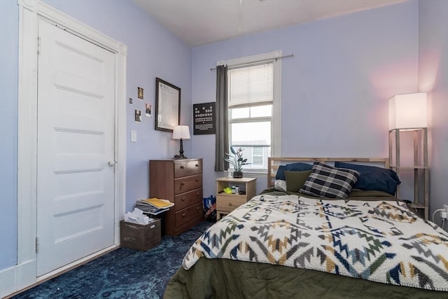 bedroom with dark colored carpet