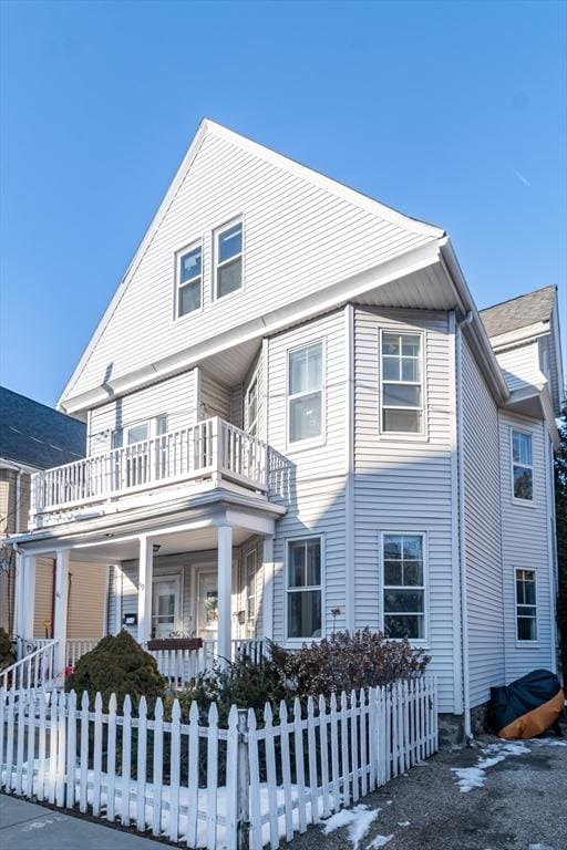 view of front facade with a balcony and covered porch