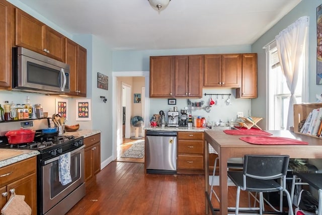 kitchen with stainless steel appliances and dark hardwood / wood-style floors