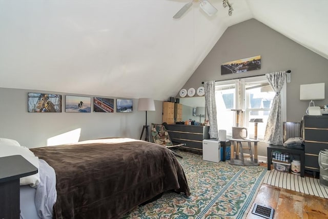 bedroom with wood-type flooring, lofted ceiling, and ceiling fan