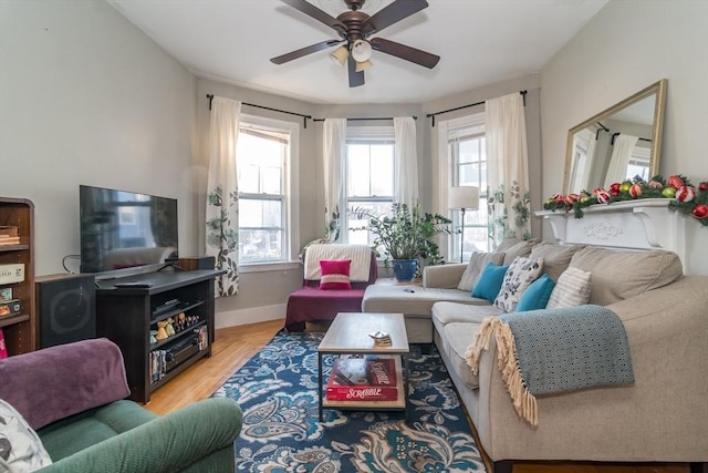 living room featuring ceiling fan and light hardwood / wood-style floors