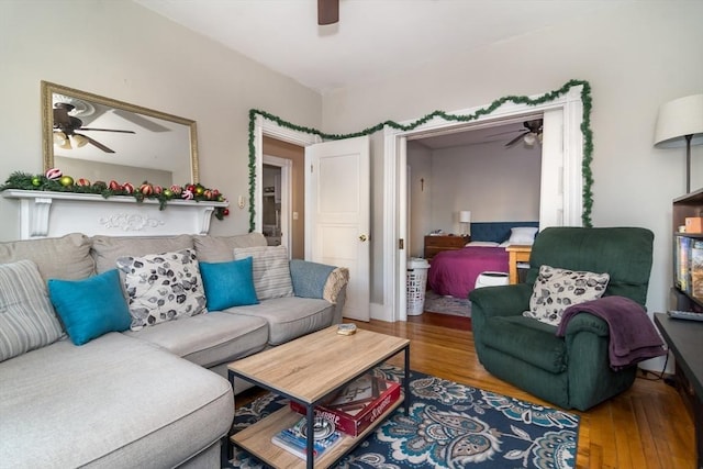 living room with wood-type flooring and ceiling fan