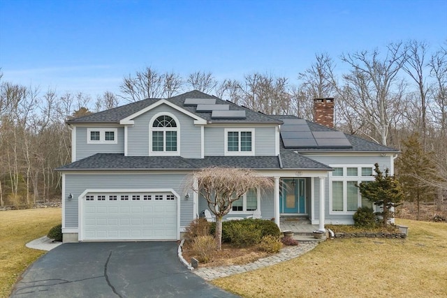 33 Gulf Hill Dr, Dartmouth, MA 02748 - traditional home featuring driveway, covered porch, an attached garage, roof mounted solar panels, and a front yard