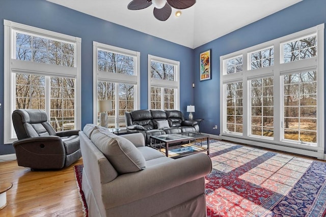 33 Gulf Hill Dr, Dartmouth, MA 02748 - living area with baseboards, a towering ceiling, a ceiling fan, wood finished floors, and baseboard heating