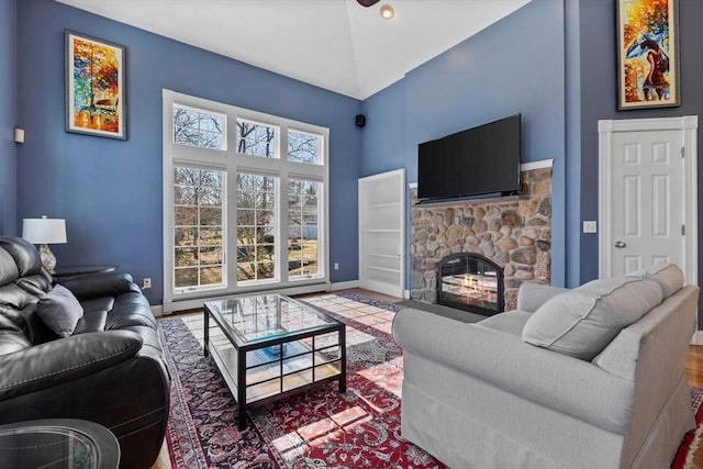 33 Gulf Hill Dr, Dartmouth, MA 02748 - living area with a stone fireplace, a towering ceiling, baseboards, and wood finished floors